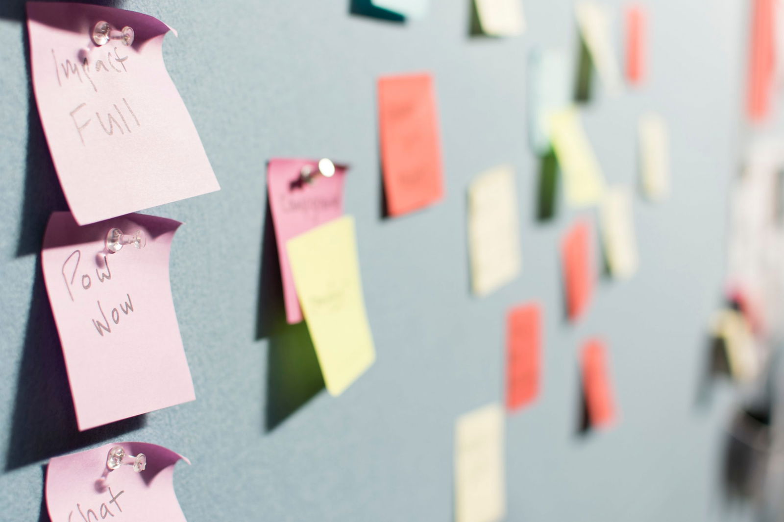 image of colorful post-it notes pinned on a bulletin board