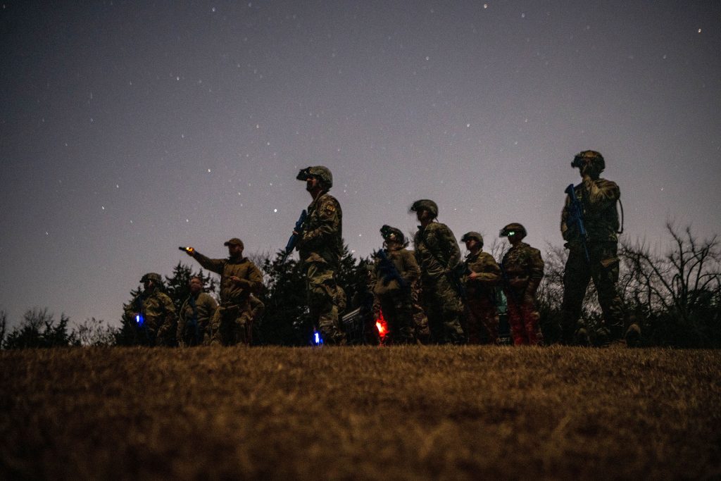Mission Sustainment Team (MST) students use AN/PVS-31A binocular night vision goggles during a field exercise in Oklahoma City, Feb. 10, 2022. The MST students used the night vision devices to learn how to observe their surroundings as well as conceal their movement in the dark.
